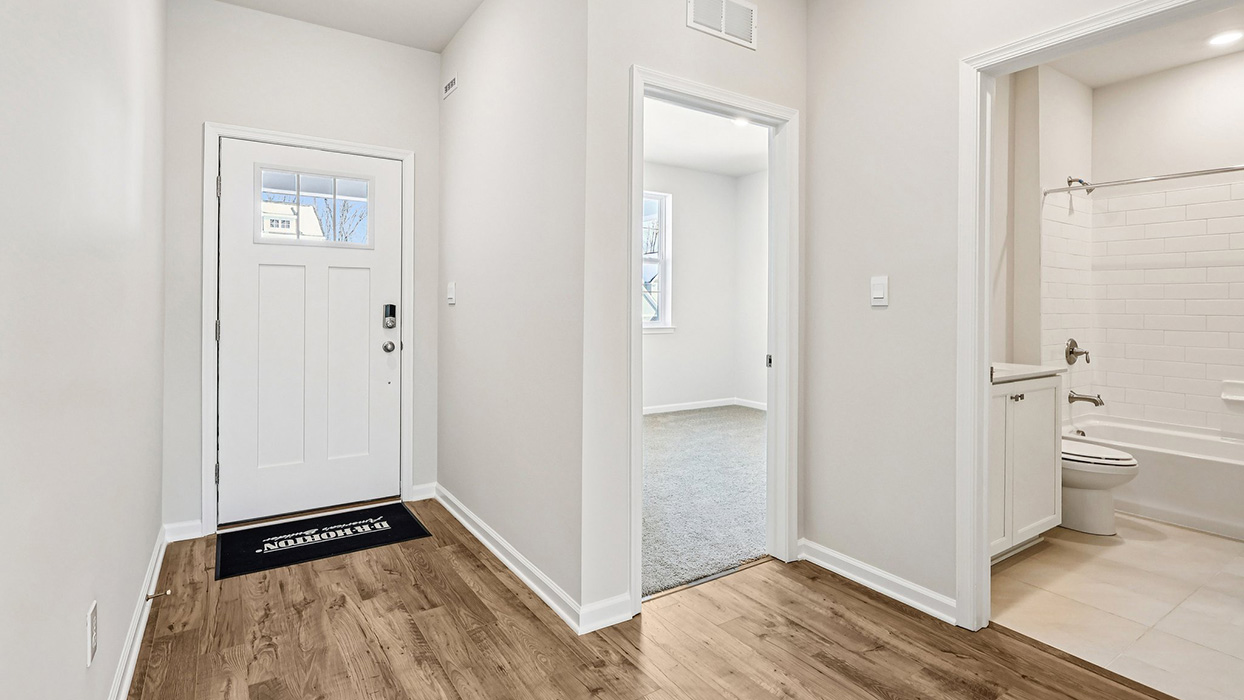 Entryway foyer with a view into bedroom two and bathroom two
