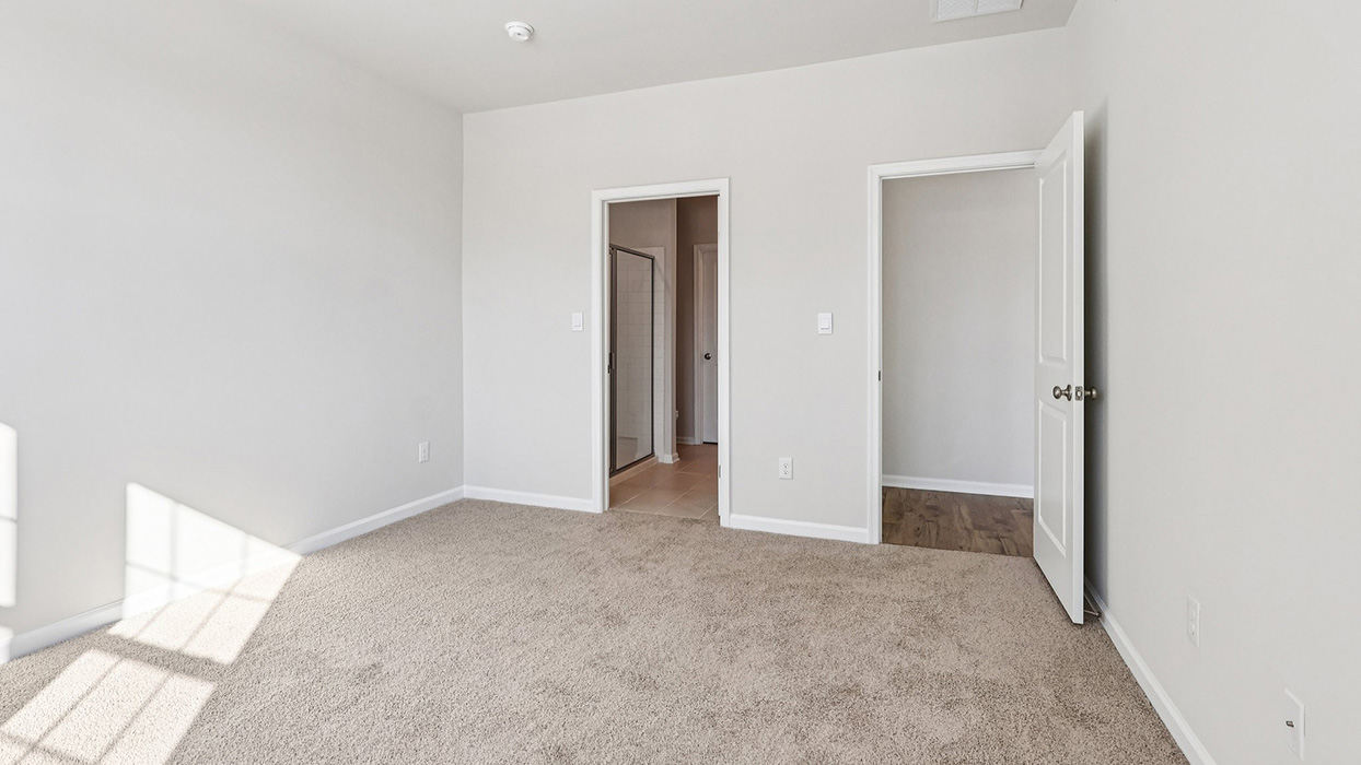 A different view of the primary bedroom with walk in closet