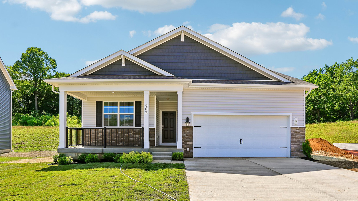 Front exterior of Hamilton home at Reserve at Lakeside with covered porch, white columns, and two-car garage with stone accents.