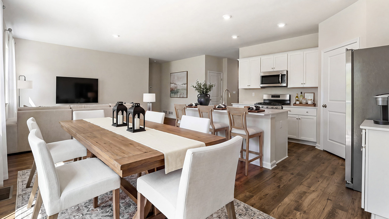 Spacious kitchen and living space with quartz island, stainless steel appliances, and seamless flow into the main living area.