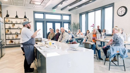 Cooking class taking place in the Amblebrook amenity center's kitchen.