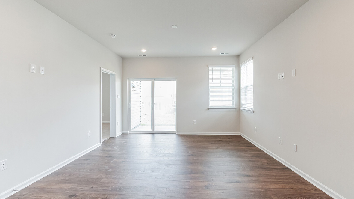 The living area has two single windows and a sliding door which leads to the covered patio