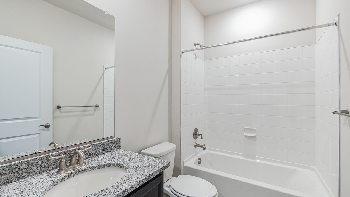 A second full bathroom is located near the second and third bedrooms.