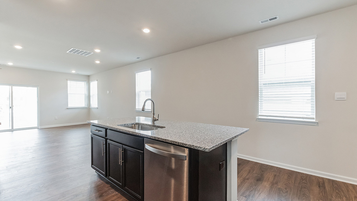 The kitchen is open to the informal dining area with a view into the living area.