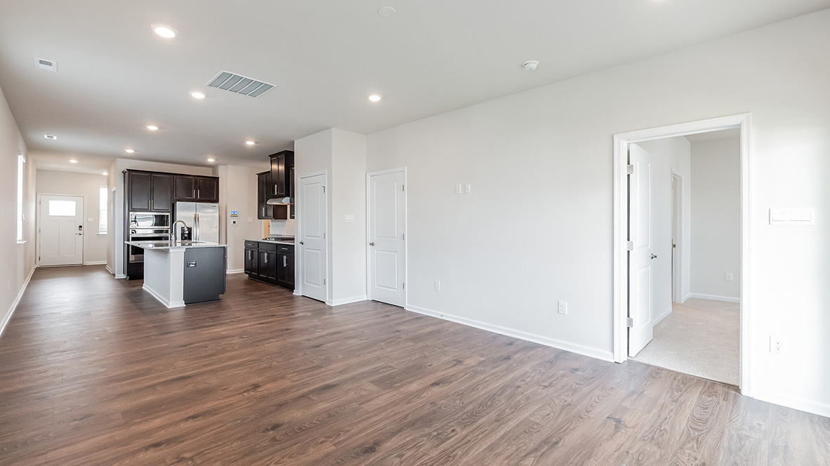The open concept living area with a view back through the dining area towards the kitchen.