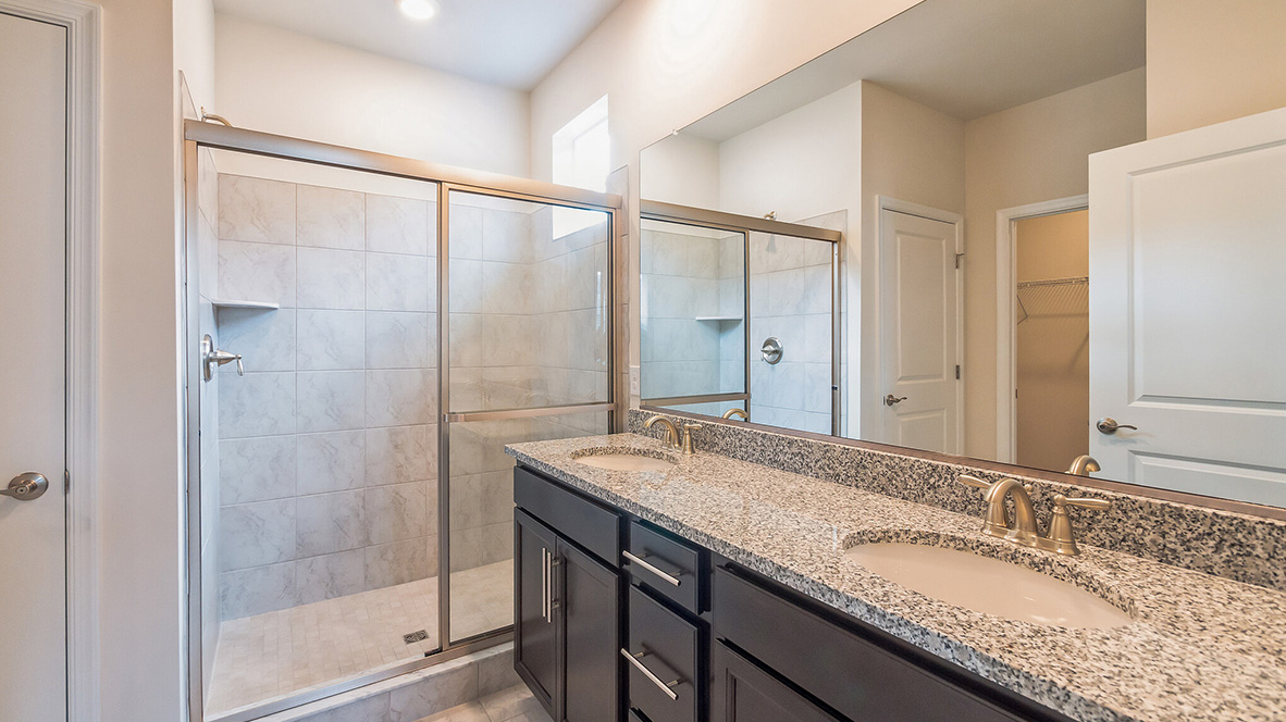 The primary bathroom with double bowl vanity.