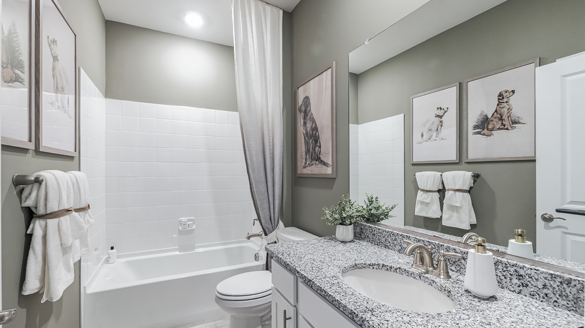 A second full bathroom is located in the foyer hallway between the second and third bedrooms.