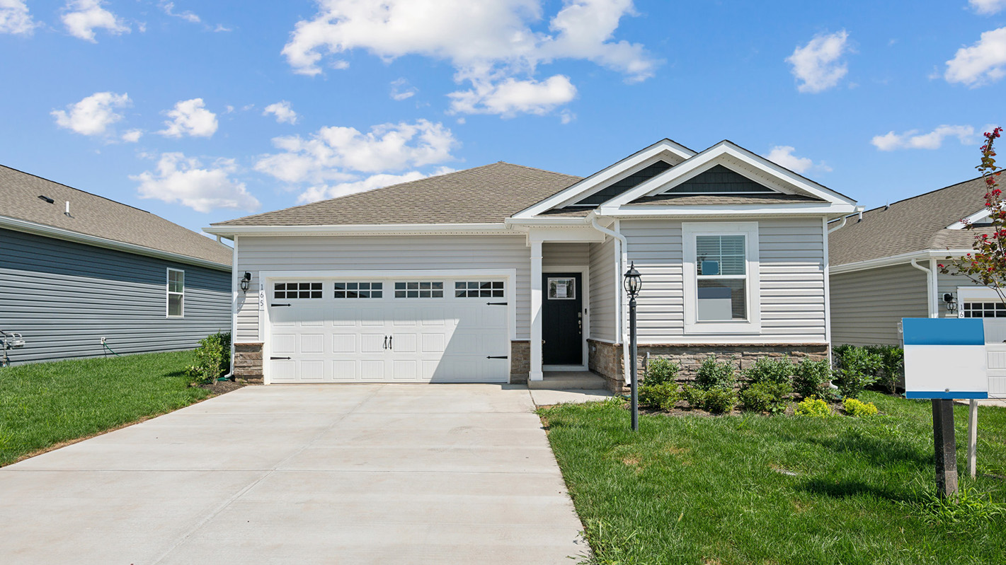 A Dawson home with white siding and trim and a two car garage