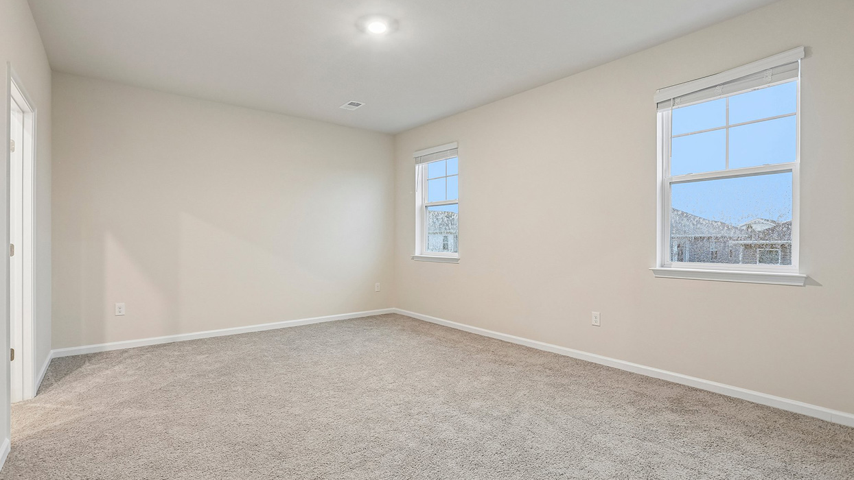 Comfortable secondary bedroom with flexible space for guests, family members, or a dedicated home office.