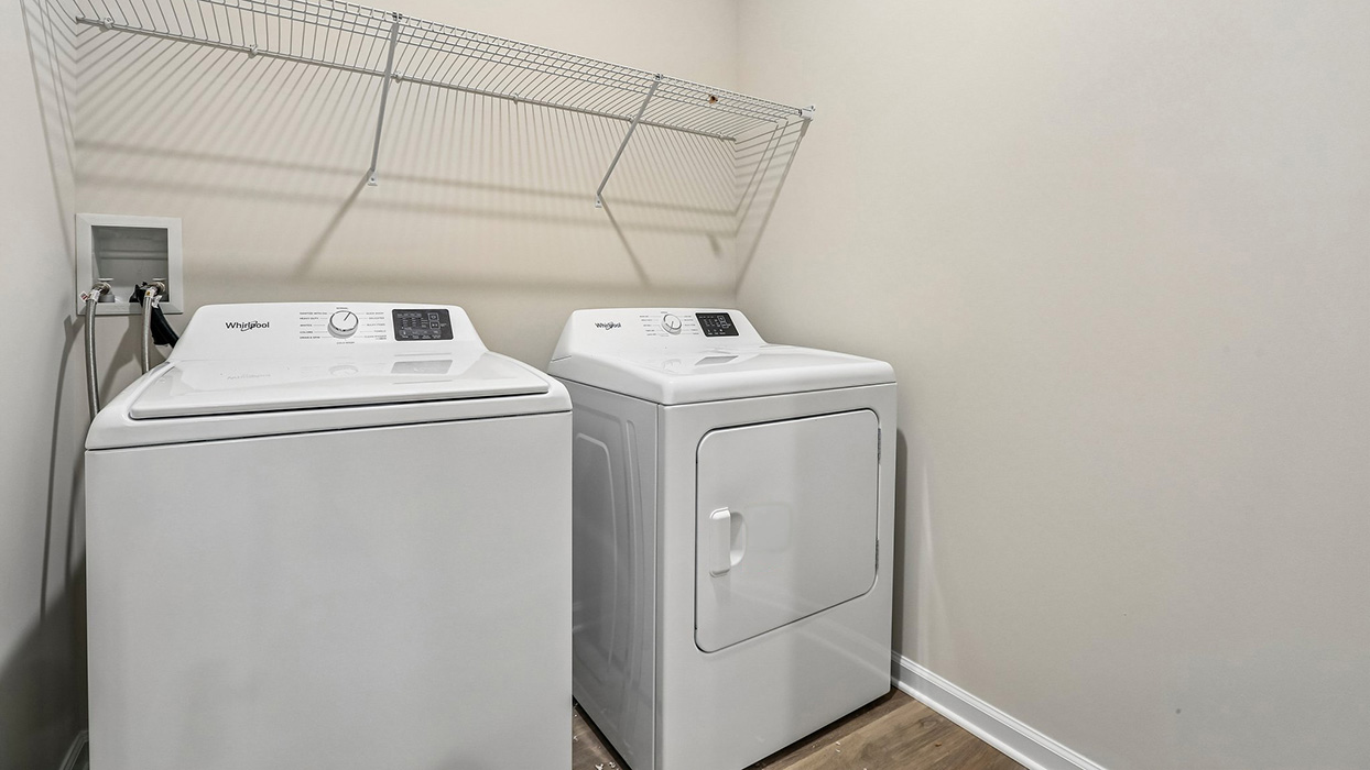 Dedicated laundry room offering added convenience and everyday functionality with space for storage and organization.