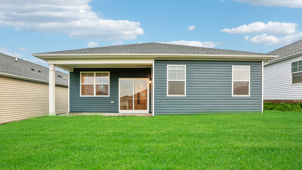 Covered rear patio and backyard space offering opportunities for outdoor dining, relaxation, and seamless indoor-outdoor living.