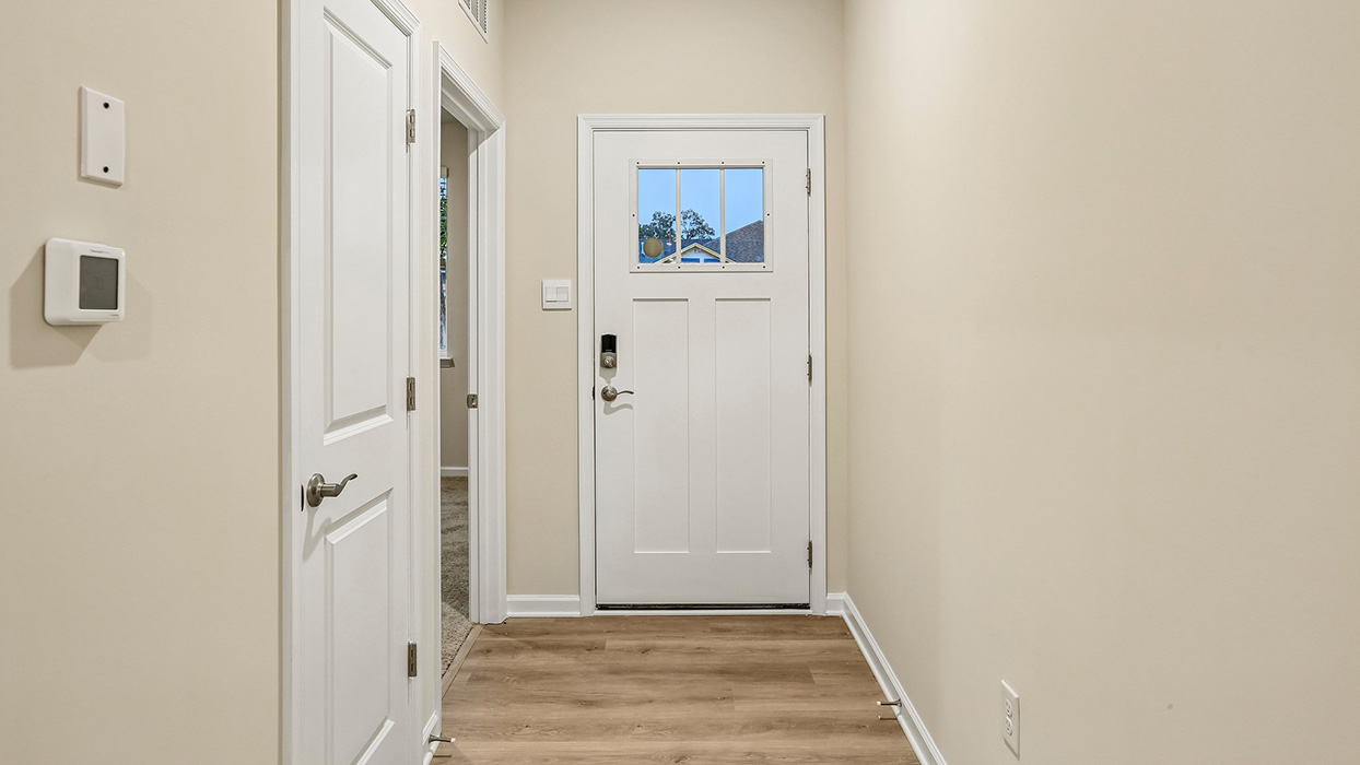 Welcoming entry foyer that provides a functional transition into an open-concept floorplan designed for easy flow and everyday convenience.