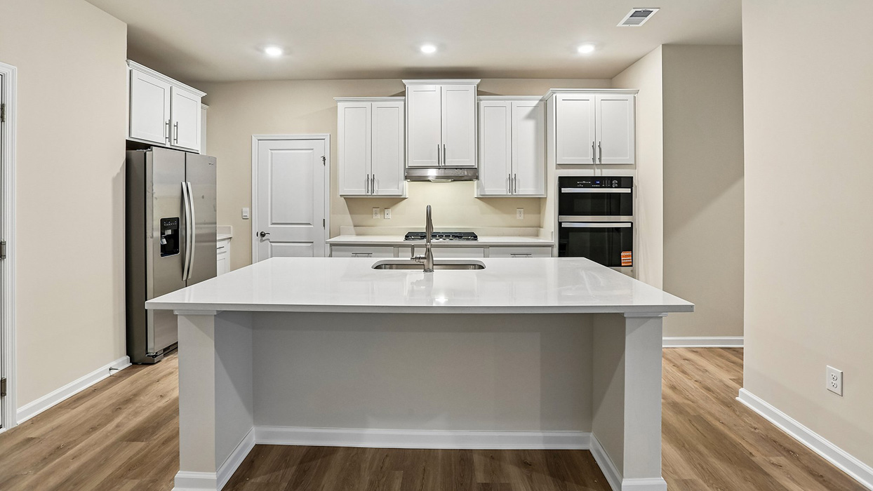 Modern kitchen featuring a large island, ample storage, and an open design that keeps the heart of the home connected to surrounding living spaces.
