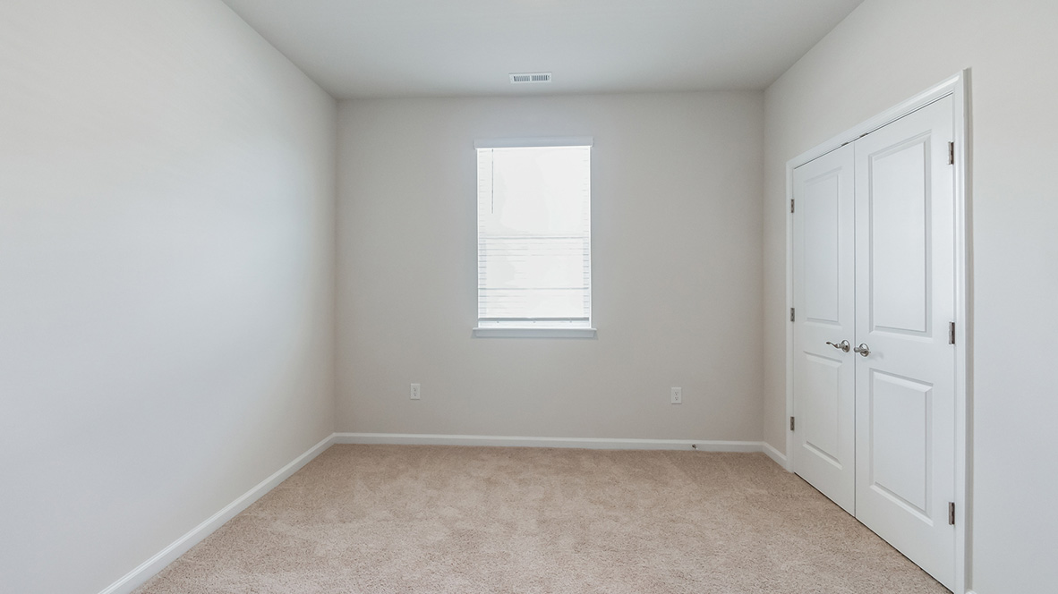 A secondary bedroom with single window.