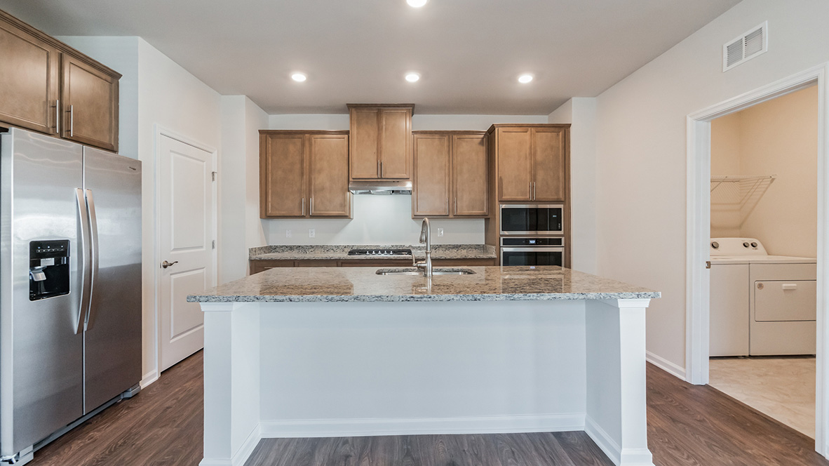 The kitchen with a side view into the adjacent laundry room.