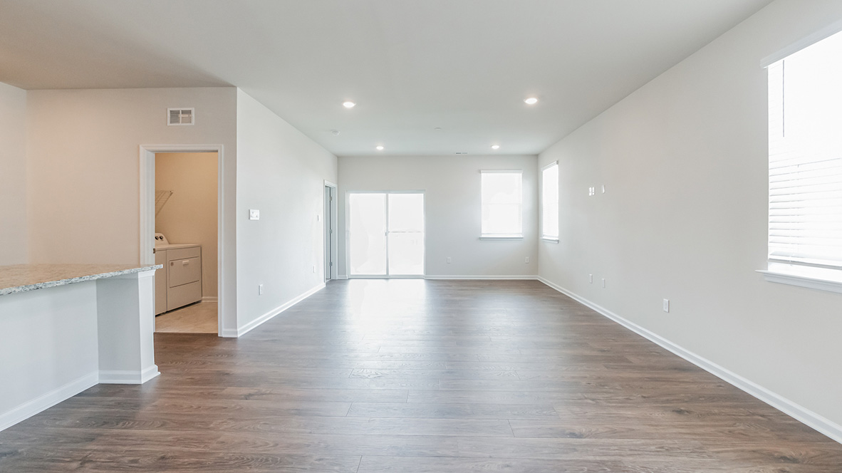 The living area has two single windows and a sliding door which leads to the covered patio