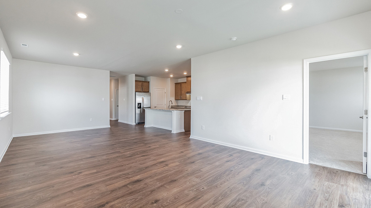 The open concept living area with a view back through the dining area towards the kitchen.