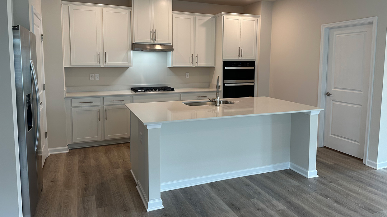 The kitchen with a side view into the adjacent laundry room