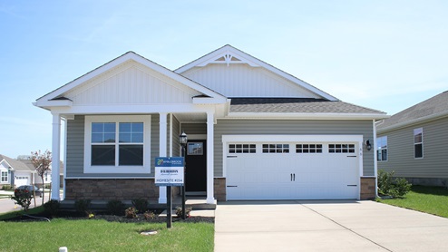 A rendering of a Merrit home with dark blue siding, gray board and batten accent sideing, white trim, and white two car garage