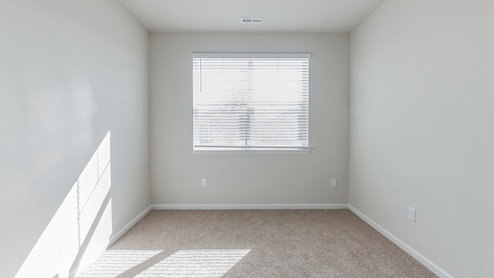 A third bedroom with a double window.