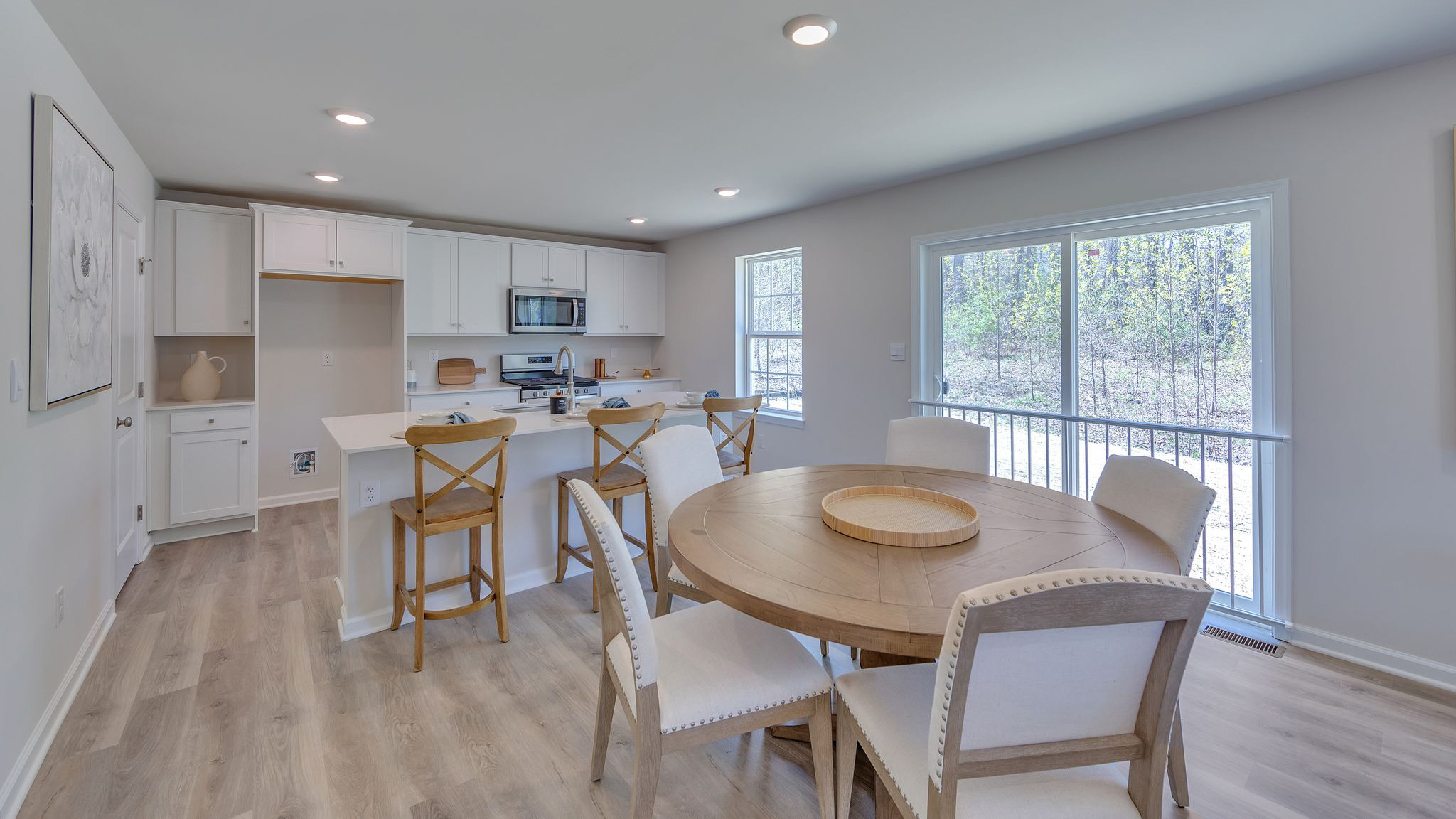 Dining area that overlooks sliding glass door to backyard.