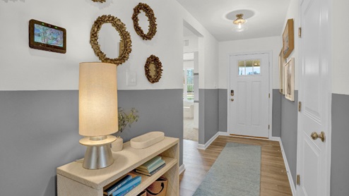 As you enter the inviting foyer, the short hallway will lead you inside the home.