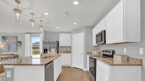 A large kitchen pantry is in the corner of the kitchen.