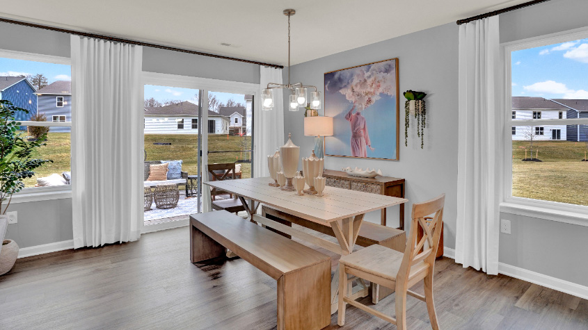 The expansive great room, with an abundance of natural light, flows seamlessly into the dining area.
