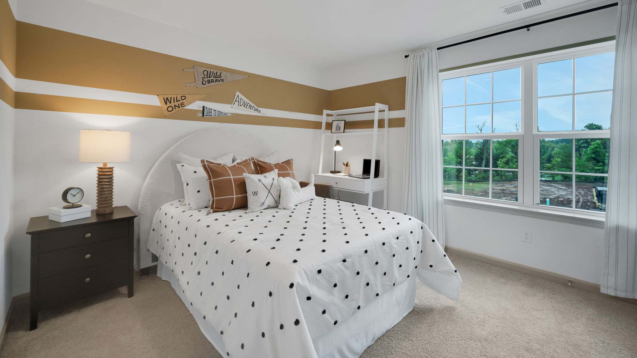 Secondary bedroom with a double bed, nightstand, desk with desk chair, and a double window.