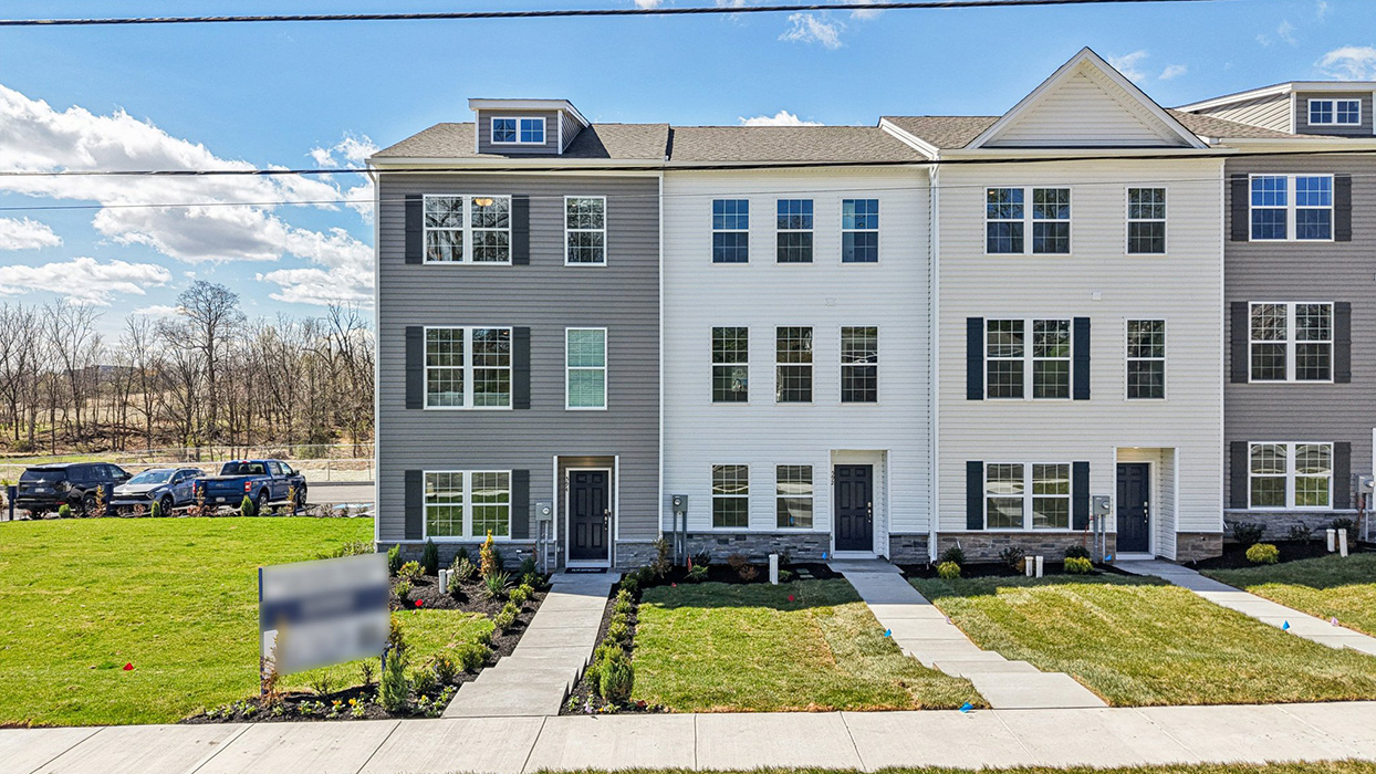 a front view of a townhome in white color