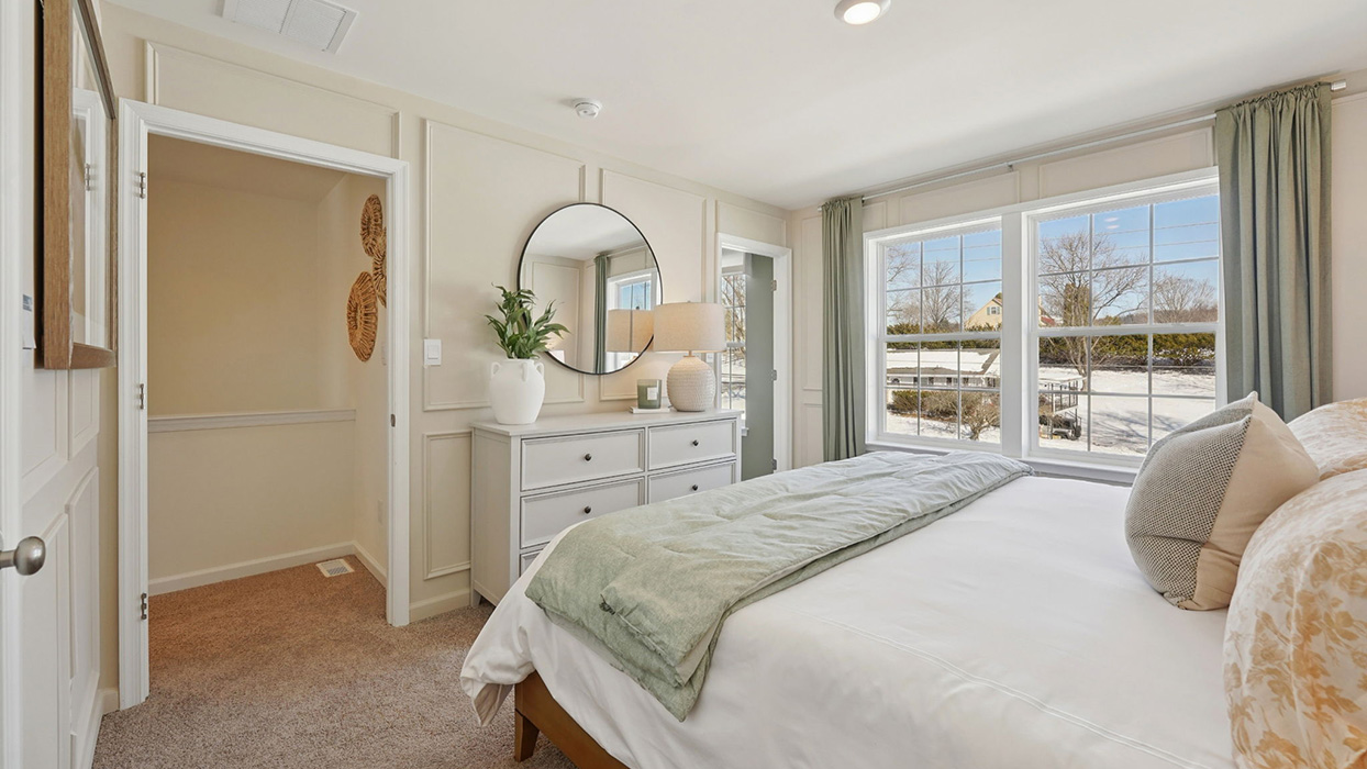 Primary bedroom with a peek into the hallway