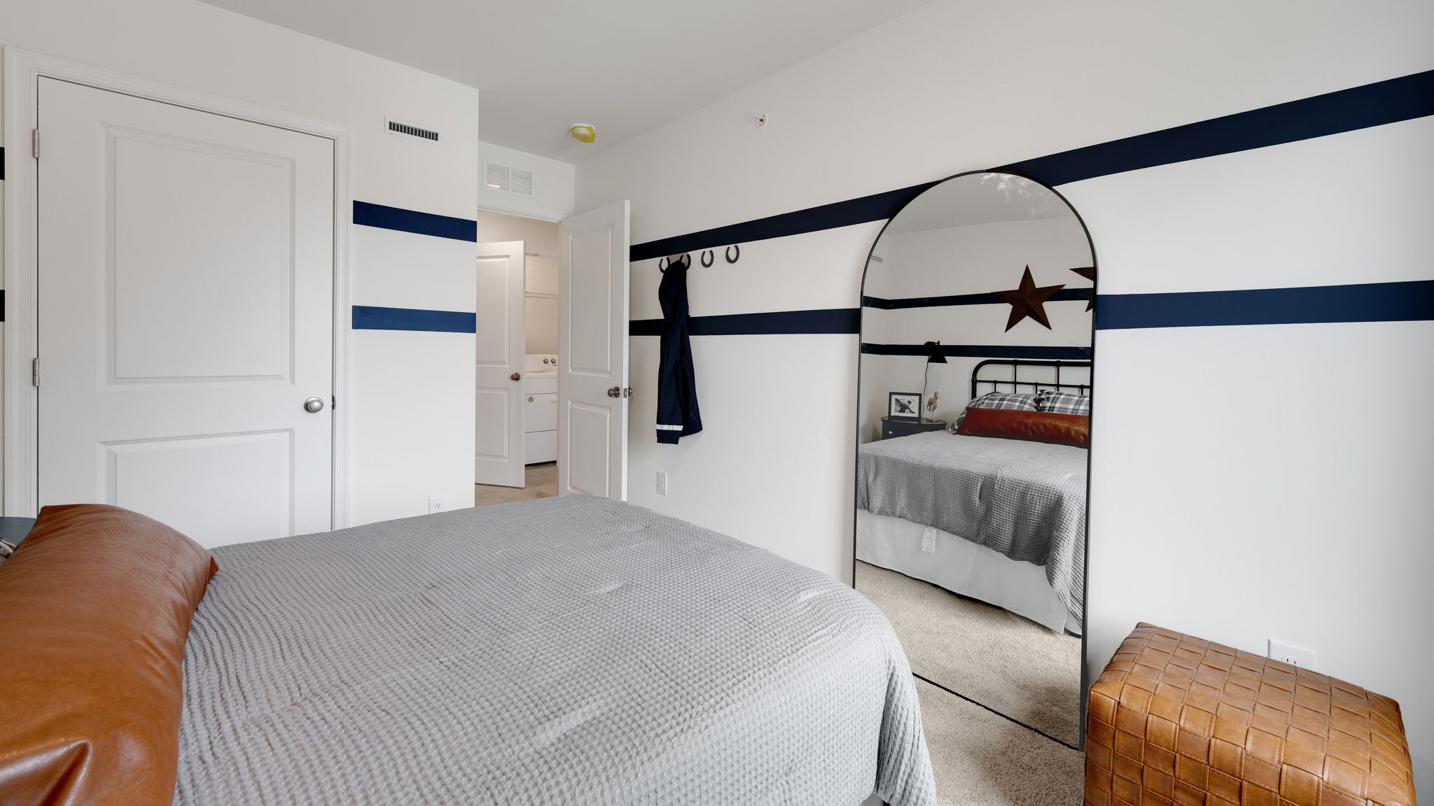 A different view of the second bedroom with closet door in view.