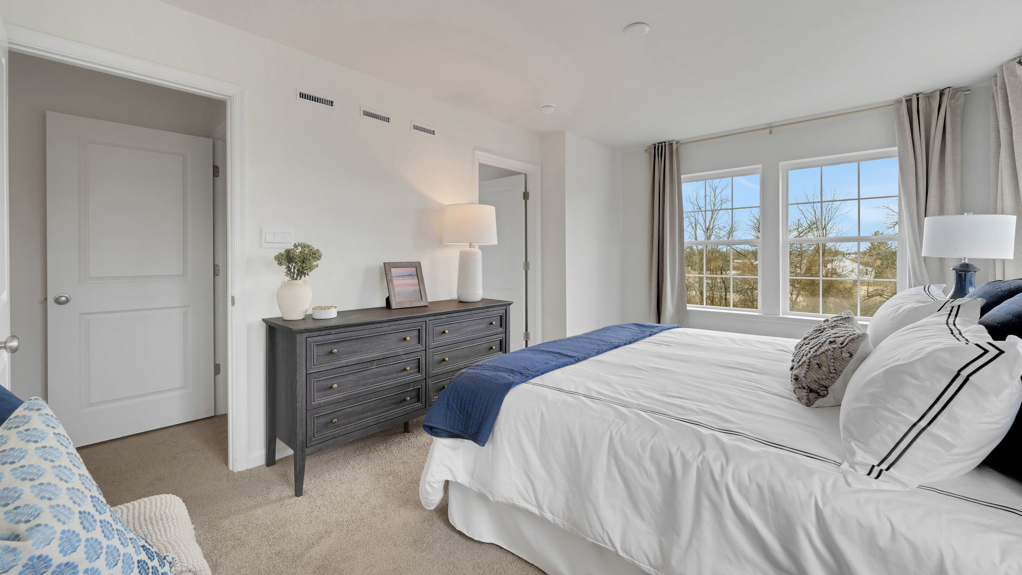 Primary bedroom with view into the walk-in closet.