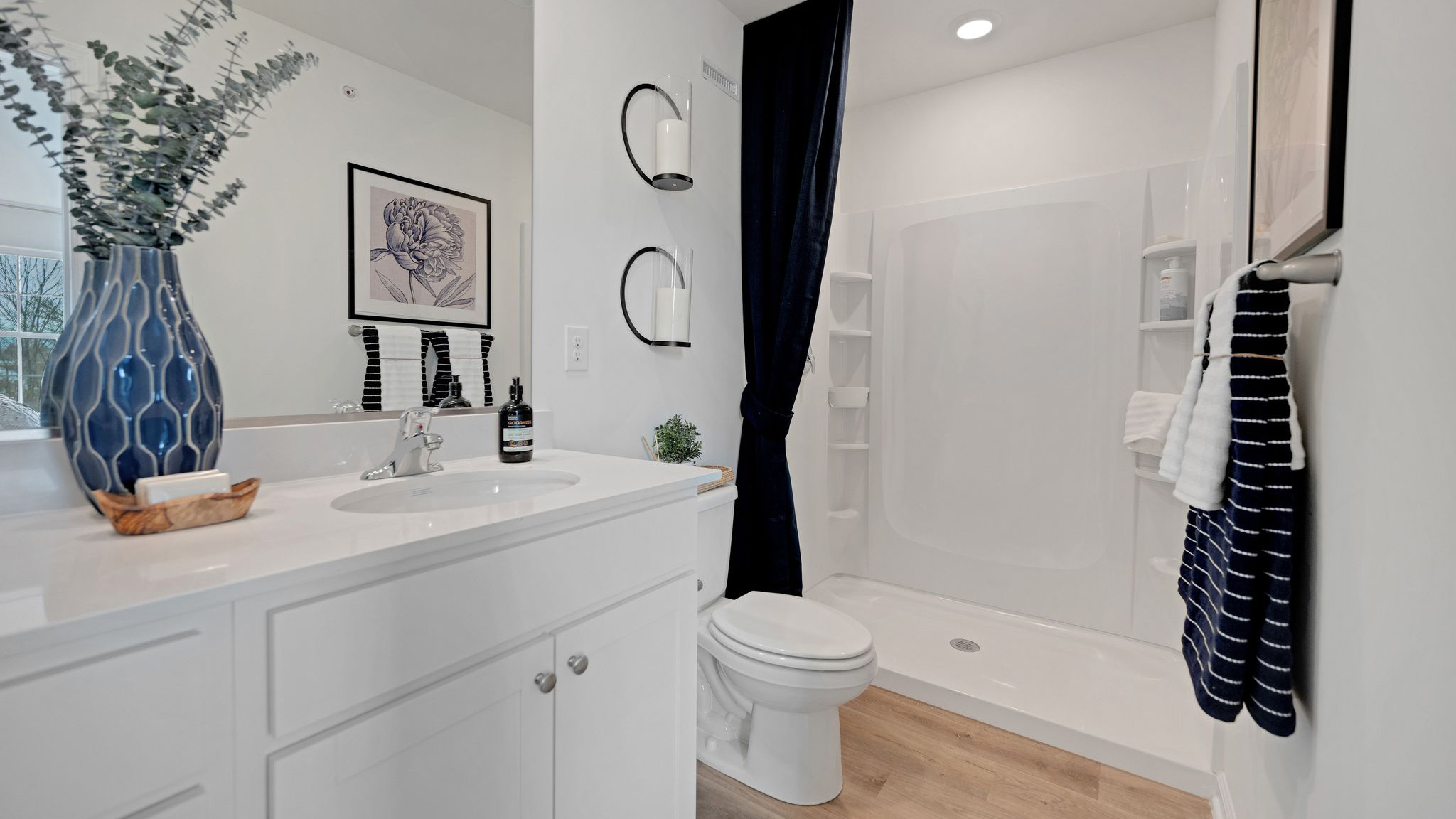 Primary bathroom with double vanity and walk-in shower.