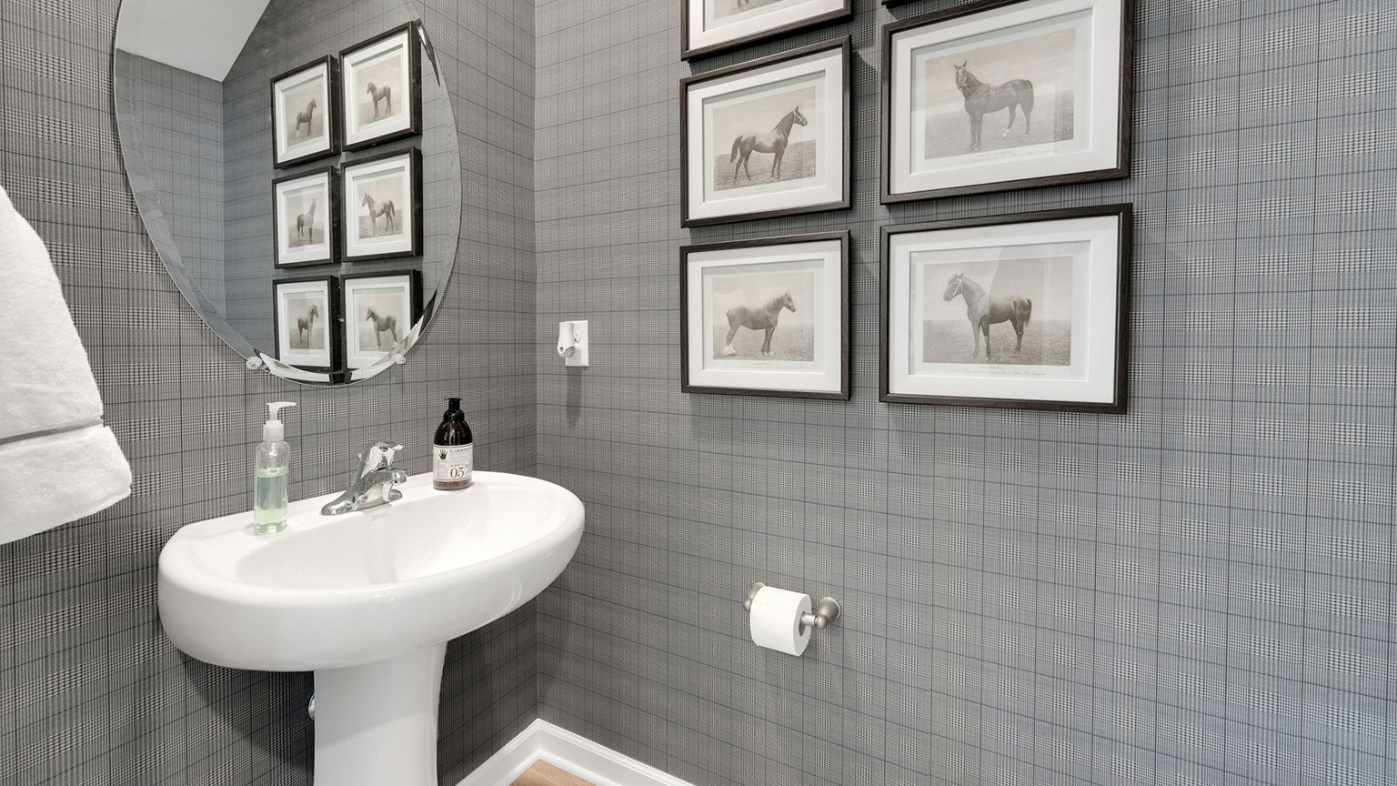 Half bath with single sink on the first floor.