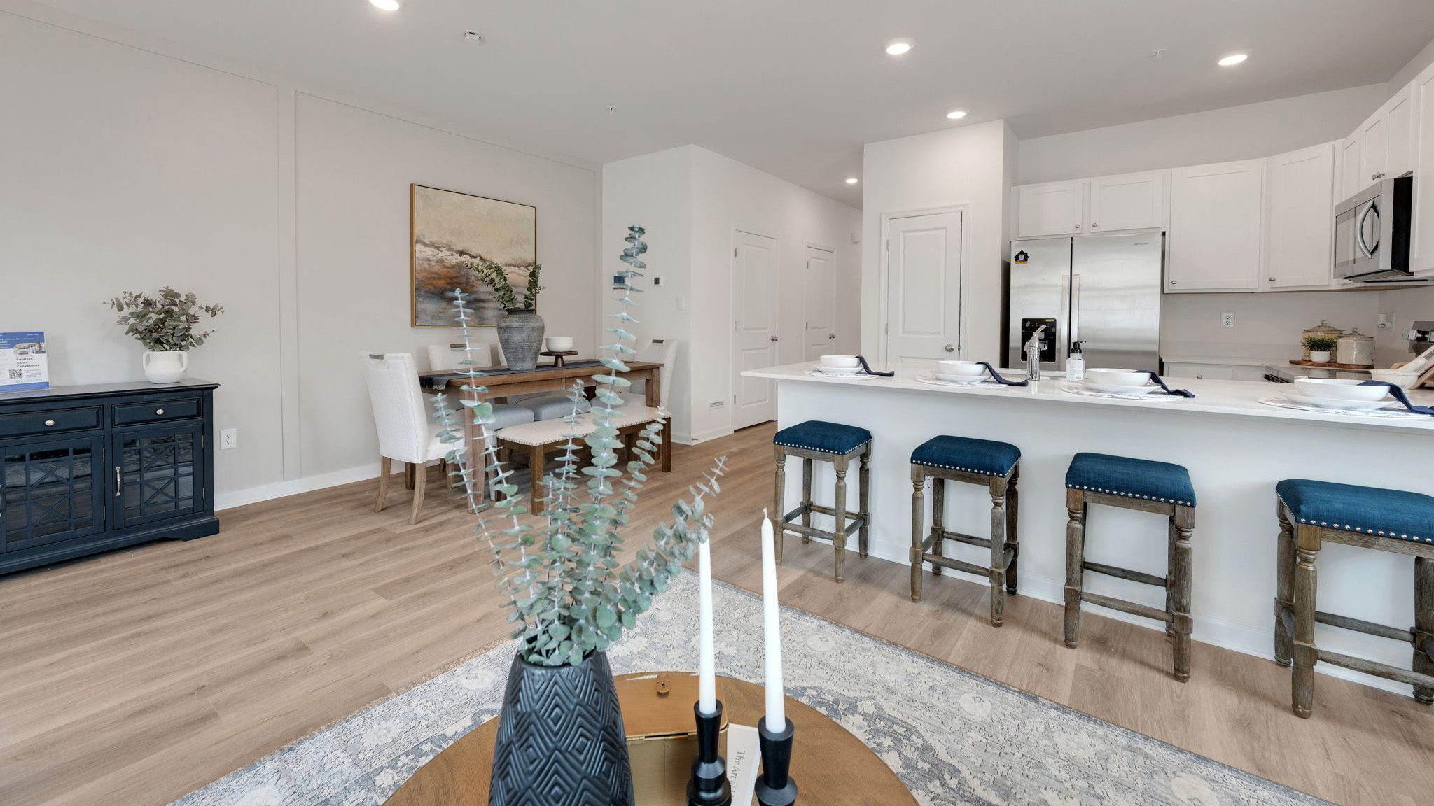 The dining, living, and kitchen area in view for an open concept plan. View from in front of the back door.
