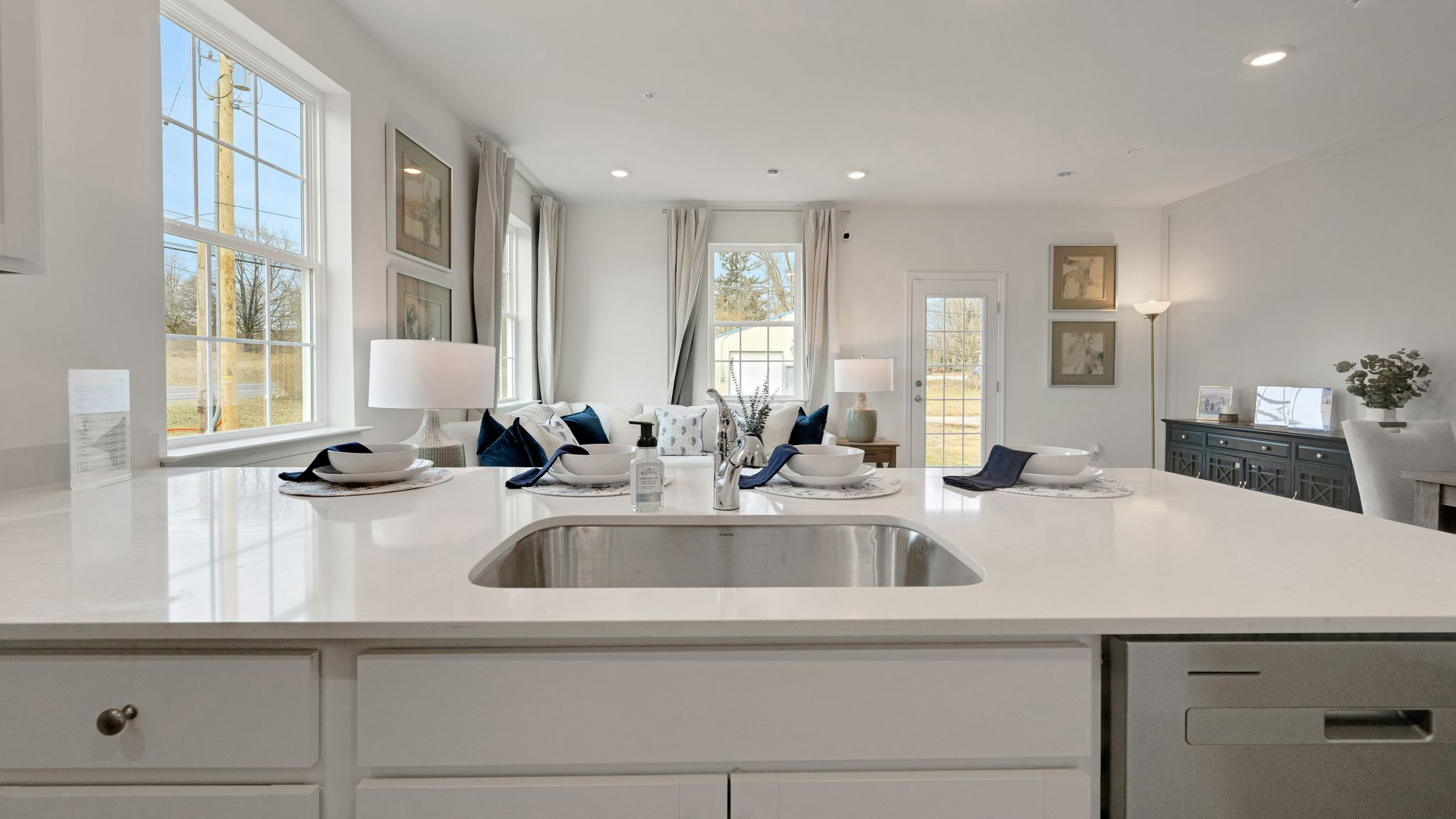 Behind the kitchen counter with view of the sink.