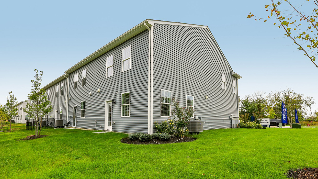 Exterior rear image of the model townhome with dark gray horizontal paneling