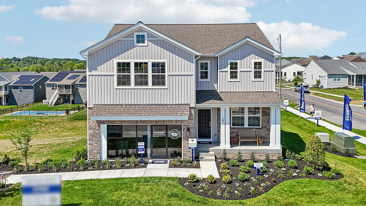 An aerial photo of a two-story Galen home with ironstone and cream siding, and full stone.