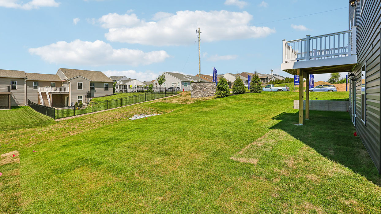 A side-view of the raised back porch and expansive backyard.