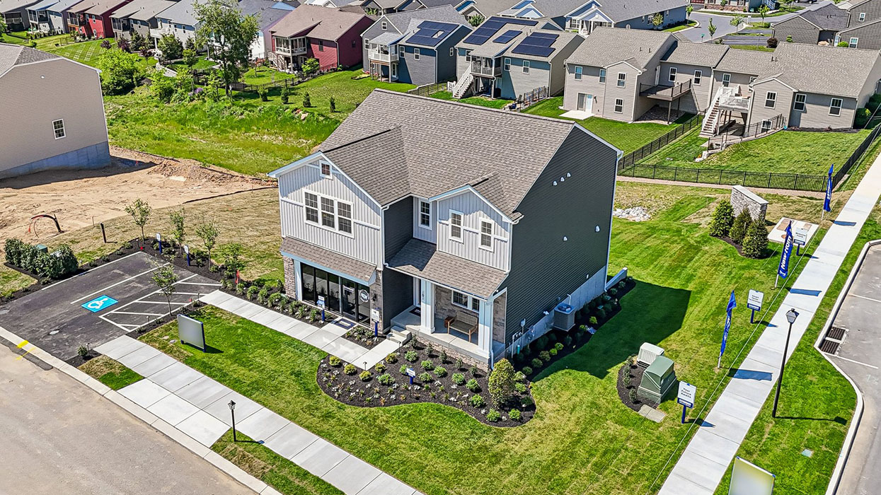 A birdseye view of a two-story Galen home with ironstone and cream siding, and stone kneewall with home icon pin.