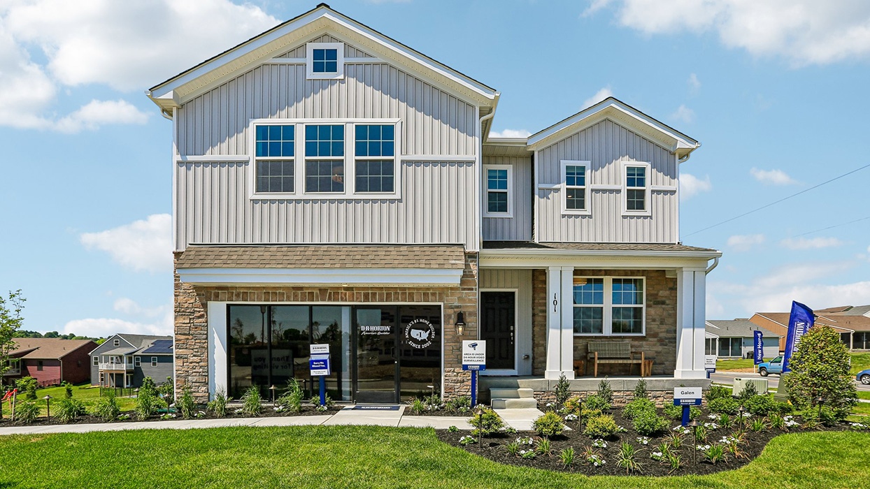 A photograph of a two-story Galen home with ironstone and cream siding, and stone siding.