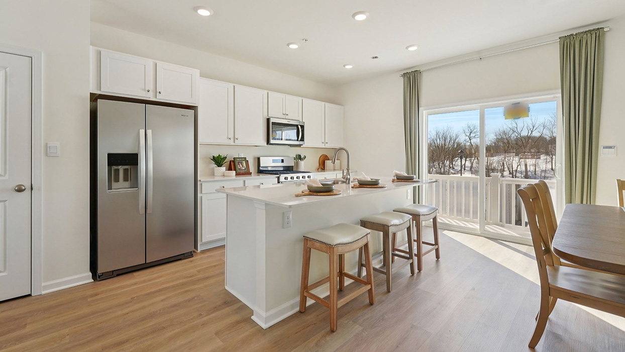 Kitchen area with sliding glass door and small deck on the back