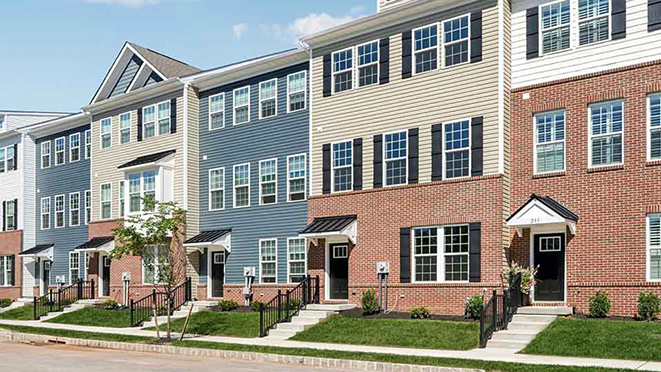 an angled view of a three-story townhome building with 6 units.