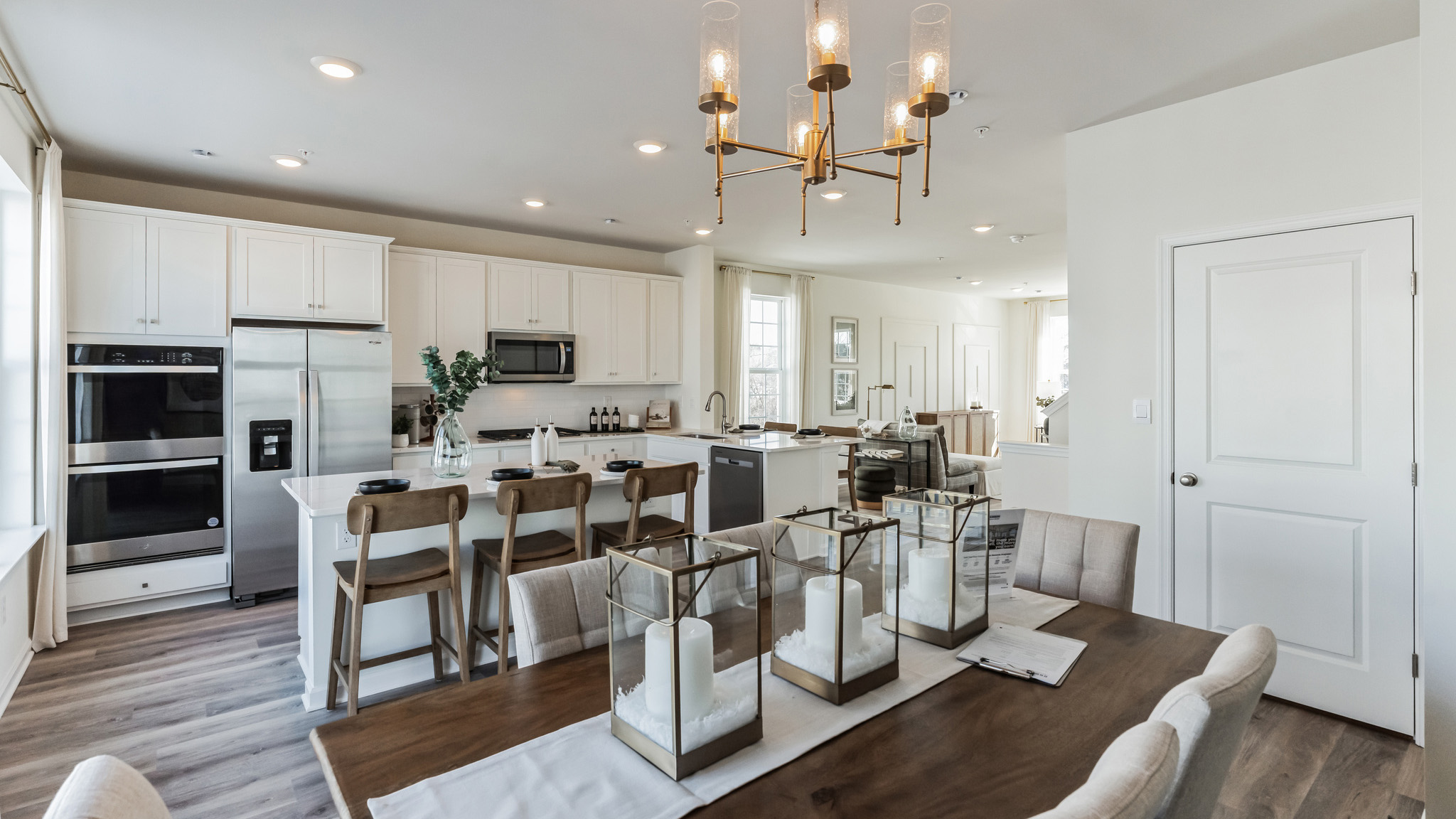 Dining area with pantry door behind, kitchen area to the left, peek into the living area in the very back.