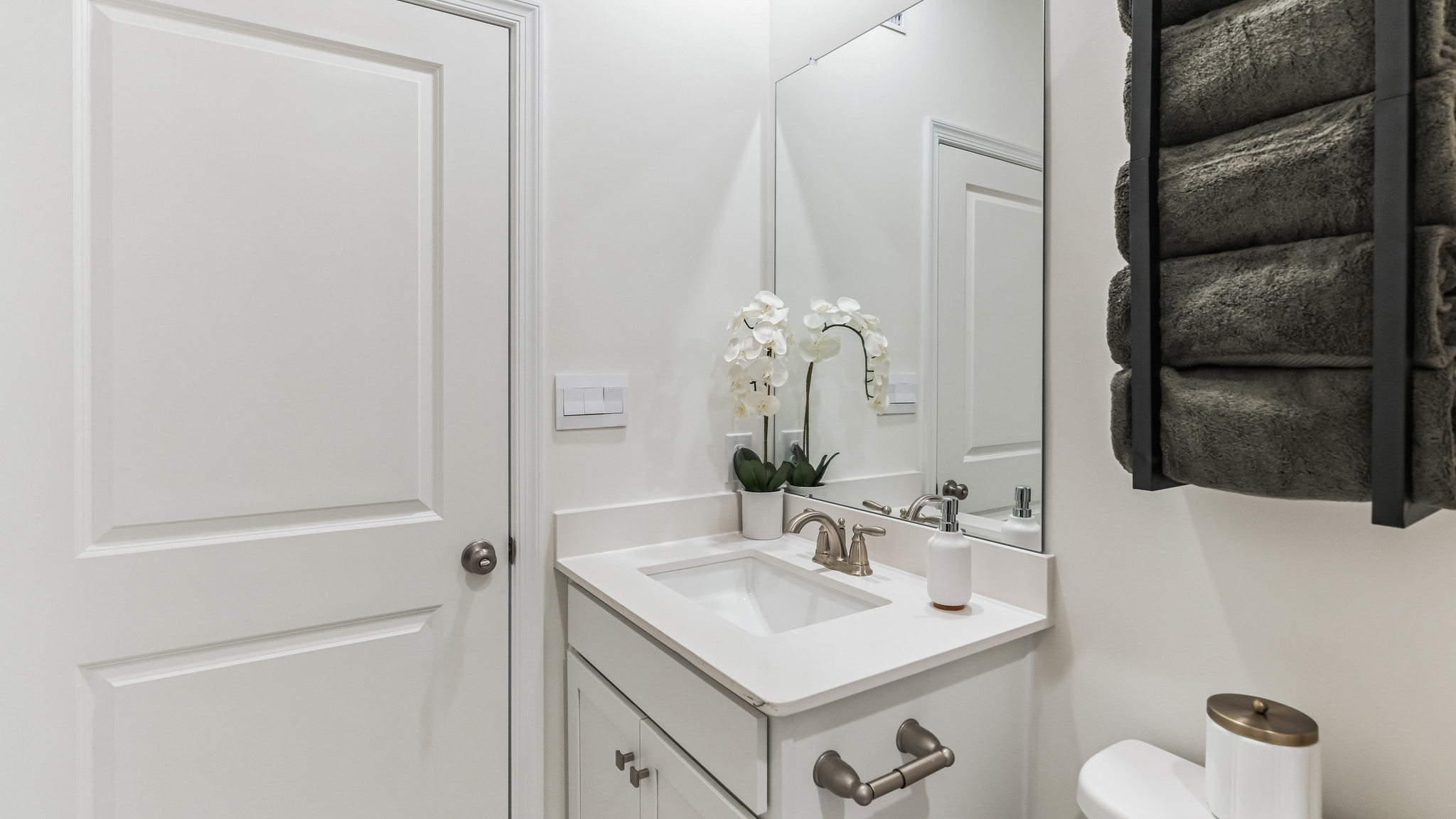 Different view of the full bath with single sink white vanity and bathtub.