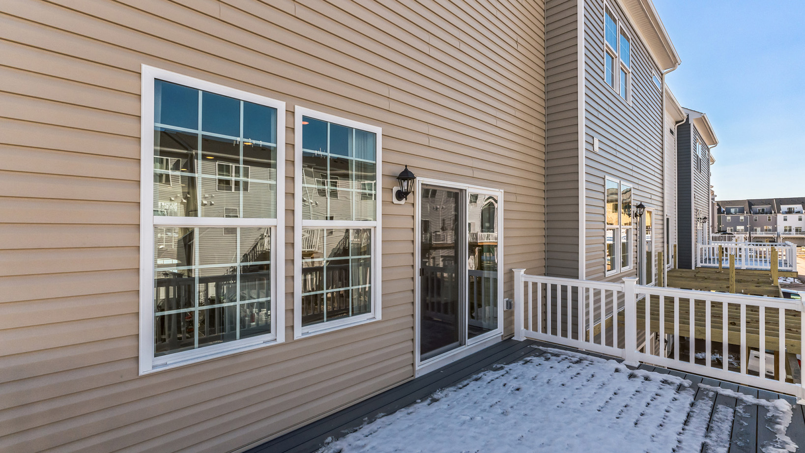 Different view of the deck area with view of the back sliding glass door.