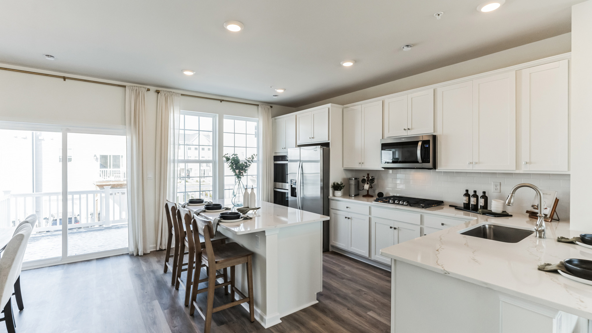 vLarge kitchen area with the back sliding door to the deck.