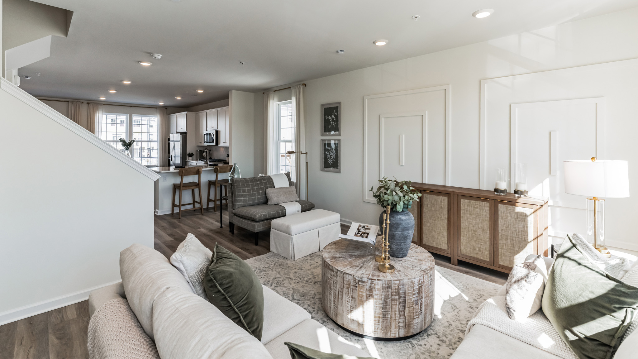 Living area standing near the half bath with view of the kitchen area in the back.