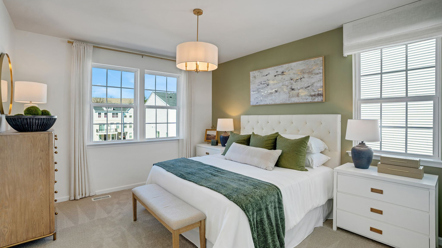Primary bedroom with three windows.